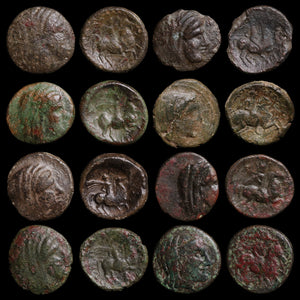 Collection of ancient bronze coins with varying degrees of wear on a black background